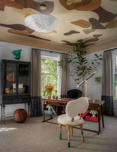 a living room filled with furniture and a painting on the ceiling