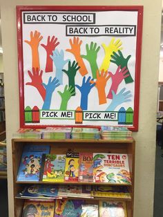 the back to school book stand is full of children's handprinted books