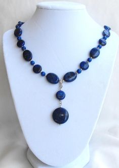 Beautifully designed natural blue Lapis Lazuli dangle pendant beaded necklace. One of a kind. Blue Beaded Dangle Necklaces With Natural Stones, Blue Beaded Necklaces With Natural Stones And Dangle Shape, Blue Beaded Necklaces With Natural Stones, Blue Dangle Gemstone Beads Necklace, Blue Gemstone Beads Dangle Necklaces, Blue Pendant Beaded Necklace With Single Strand, Bohemian Single Strand Lapis Lazuli Necklace, Blue Dangle Necklaces With Gemstone Beads, Blue Dangle Necklaces With Polished Beads