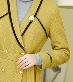 This elegant mustard pantsuit comes with a waist-sash blazer and flare-bottom pants for a sophisticated aesthetic that can be styled in endless ways. Black trim on collars and sleeves Blazer: Lined, double-breasted button closure Blazer: Long sleeves, shawl collar, front flap pockets Pants: Zip fly with hook-and-button closure Pants: Front slant pockets 50% wool,50% polyester Dry Clean Item #2816 Women's blazer & pant two-piece set SIZE INFO XS=US2=UK6=EU32 S=US4-6=UK8-10=EU34-36 M=US8-10=UK12-1 Beige Long Sleeve Tweed Jacket For Winter, Cream Wool Long Sleeve Outerwear, Cream Wool Coat With Button Closure, Tailored Beige Wool Coat With Long Sleeves, Chic Tweed Jacket With Suit Collar For Winter, Elegant Beige Tweed Jacket For Winter, Cream Long Sleeve Tailored Outerwear, Elegant Cream Tweed Jacket For Winter, Cream Long Sleeve Outerwear For Tailoring