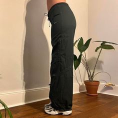 Deadstock Vintage Nike joggers / parachute pants in dark green . Come brand new with tags on. Size: Medium / UK12 (modelled size) Model is typically uk8 but wearing a 12 for a more loose/oversized fit - have drawstrings on waist to fit smaller sizes xx Instant buy is on! Available ✅ Instant buy is on! Measurements: Inside leg 31.5" Model is 5'6 and is typically size UK8  We ship internationally: message us for international postage prices before purchasing.  Items are dispatched next day (mon - sat).  Vintage Deadstock condition with tags still on.       Nike tracksuit bottoms  Nike cargos Casual Green Pants For Gym, Casual Nylon Joggers With Drawstring, Sporty Nylon Joggers With Drawstring, Sporty Cargo Long Pants, Sporty Cargo Style Sweatpants, Full Length Joggers With Drawstring For Streetwear, Sporty Cargo Style Long Pants, Green Straight Leg Pants With Drawstring, Sporty Cargo-style Parachute Pants