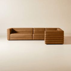 a brown couch sitting on top of a white floor