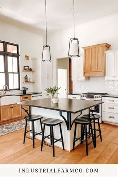 a kitchen island with stools in the middle and an open floor plan on the other side