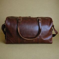 Large Size - 16" x 10 ½" x 4 ¼" (43.18cm x 31.75cm x 10.795cm) Strap adjusts - 40 1/2" to 54 1/2" Strap width - 1 1/2" - Leather shoulder pad included One front pocket One outside pocket for quick access, leather divider inside with three pockets sewn to the divider. Color - "C2" Antique Saddle Black hand rubbed oil finish. Burnished finish interior Leather - Full grain, Veg tanned leather 100% of stitching is HAND SEWN. ❤️Uncover the perfect travel companion with our Vintage Style Distressed Le Vintage Leather Duffle Bag For Everyday Use, Vintage Leather Duffle Bag, Vintage Leather Duffle Bag With Waxed Finish, Vintage Brown Hand-tooled Travel Shoulder Bag, Vintage Leather-lined Duffle Bag For Travel, Leather Duffel Bag, Handmade Handbag, Leather Duffel, Handcrafted Bags