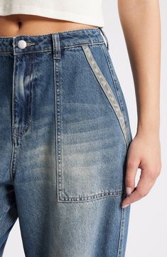 These baggy, high-waist jeans are designed with edgy rips, stitching detail and dramatic wide legs. 31" inseam; 22" leg opening; 13 1/2" front rise; 17" back rise (size 29) Zip fly with button closure 70% cotton, 30% Tencel® lyocell Tencel lyocell is a more-sustainably produced fiber made with closed-loop processing Machine wash, tumble dry Five-pocket style Imported Spring Utility Wide Leg Flare Jeans, High Rise Flare Jeans With Contrast Stitching For Spring, Trendy Medium Wash Bottoms With Contrast Stitching, Spring Flare Jeans With Contrast Stitching In Medium Wash, Utility Style Baggy Flare Jeans, Baggy Wide Leg Utility Flare Jeans, Spring High Rise Utility Flare Jeans, Spring High-rise Utility Flare Jeans, Trendy Wide-leg Cargo Jeans With Frayed Hem