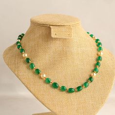 This elegant necklace features exquisite green quartz beads paired with lustrous pearls, creating a stunning combination. The addition of gold beads interspersed between the quartz enhances the piece's sophistication, while decorative caps at both ends of the beads add a touch of refinement.  Versatile in style, this necklace complements all shades of light-colored attire effortlessly. For a complete look, pair it with matching green stone stud earrings for a touch of coordinated elegance. Lengt Gold Beaded Jade Necklace, Gold Jade Beaded Necklaces With Gemstone Beads, Gold Jade Beaded Necklaces With Gemstones, Gold Jade Gemstone Beaded Necklaces, Gold Jade Necklace With Gemstone Beads, Elegant Emerald Necklace With Beaded Chain, Elegant Gold Emerald Necklace With Faceted Beads, Elegant Green Onyx Bead Necklaces, Elegant Green Onyx Beaded Necklaces