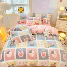 a bed room with a neatly made bed covered in pink and blue comforter sets