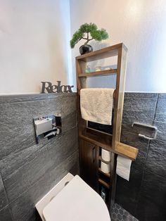 a bathroom with a toilet, sink and towel rack in it's corner area