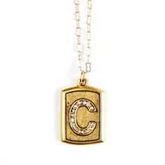 This Talisman Necklace is part of the Pave Block Initial Series, an original Sequin design embossed with the letter C and studded with crystals.  Charm measures 0.56 x 0.87" Chain measures 32" with lobster claw clasp and a 3" extender, and includes Sequin tag and crystal drop.  Materials: 22K gold-plated brass with antique finish and crystal details.  Designed & handcrafted in the USA with components from around the world. The Letter C, The Letter A, Talisman Necklace, Sequin Design, Letter C, Gold Dipped, Letter A, Lost Wax, Crystal Drop