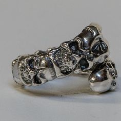 *  Awesome & unusual! Our own design of a dragon claw ring   with skulls running head to head along the ring!*  Hand made in our workshops in Devon*  .925 fully hall marked sterling silver ring*  Available in M - Z*  Special Sizes are available on request Edgy Silver Skull Ring As Gift, Edgy Silver Skull Ring For Gift, Silver Punk Rings For Streetwear, Edgy Silver Rings For Streetwear, Adjustable Silver Skull Ring Punk Style, Sterling Silver Skull Jewelry For Streetwear, Adjustable Silver Skull Ring In Punk Style, Silver Adjustable Symbolic Skull Ring, Silver Biker Jewelry For Streetwear