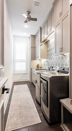 a kitchen with a washer and dryer inside of it