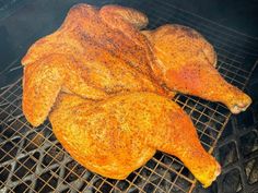 a whole chicken is cooking on the grill