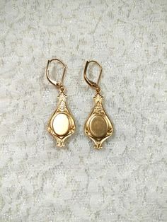 These dainty earrings are reproductions of mourning jewelry worn during the 18th and 19th centuries. They feature black and gold vintage glass and rhinestone cabochons set in vintage style brass stampings.**The back of the earring is hollow; making them super lightweight and comfy to wear. (SEE 2nd PHOTO)During the 18th and 19th centuries anchor jewels were worn as sentiments of hope and steadfastness.These elegant dangle earrings measure 1 3/4 inches long and hang from gold plated lever back ea Antique Drop Earrings With Historical Design, Antique Gold Earrings With Historical Design, Victorian Gold Plug Earrings, Antique Earrings With Historical Design, Antique Historical Drop Earrings, Vintage Earrings With Historical Design, Antique Jewelry Drop Earrings With Historical Design, Antique Jewelry With Historical Design Drop Earrings, Antique Pierced Earrings For Anniversary