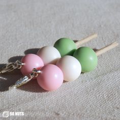 several small balls and wooden sticks on a table