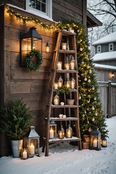 a ladder decorated with candles and wreaths in front of a house on a snowy day