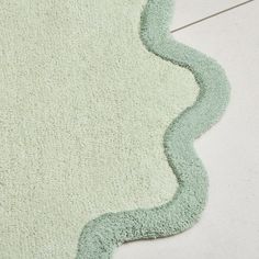 a green rug is laying on the floor