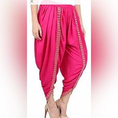 Rayon Fabric Dhoti Pants With Foil Mirror Lace. Elastic Waist Adjustable Till Size 42. Length 37”. Color Options Are Fuchia Pink Traditional Drape Summer Festive Pants, Summer Festive Pants With Traditional Drape, Festive Summer Pants With Traditional Drape, Traditional Pink Pants For Festive Occasions, Pink Fitted Traditional Pants, Bollywood Style Festive Bottoms With Traditional Drape, Bollywood Style Festive Bottoms For Spring, Festive Bollywood Style Harem Pants, Bollywood Style Harem Pants For Navratri