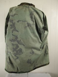 "Vintage 1980s camouflage U.S. Air Force military jacket. Made of green camo Nylon/cotton. Has U.S. Air Force patch, a button front, button cuffs, four pockets and button side cinches. Size medium long. Actual measurements are: 47\" at the chest 44\" at the waist 18\" shoulder seam to shoulder seam 26.5\" shoulder seam to end of cuff 33.5\" overall length. In excellent condition." Military Style Cotton Hunting Outerwear, Military Style Cotton Outerwear For Hunting, Military Style Green Cotton Windbreaker, Combat Cotton Camouflage Outerwear, Combat Style Camouflage Cotton Outerwear, Camouflage Cotton Combat Outerwear, Camouflage Cotton Utility Jacket For Outdoor, Winter Camouflage Cotton Utility Jacket, Military Style Camouflage Cotton Outerwear