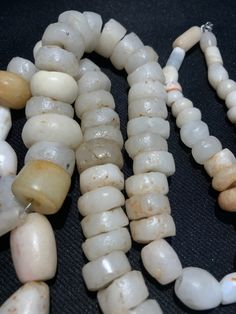 A collection of natural excavated white agate beads from ancient period as seen on its surface the patina. The holes are large and can be formed into a beautiful necklace or can be made in I individual pendants. All beads are in great condition and natural shaped White Gemstone Beads For Jewelry Making, White Beads For Jewelry Making, White Natural Stones Round Beads, White Round Natural Stone Beads, Artisan Hand-strung Rondelle Beads, White Artisan Beaded Necklaces With Oval Beads, Unique Round Gemstone Beads, Artisan Rondelle Beaded Beads, Large Rondelle Beads For Jewelry Making