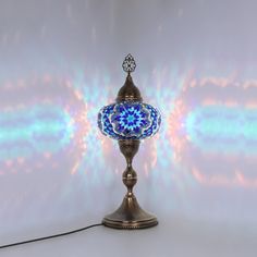 a blue and white lamp sitting on top of a table