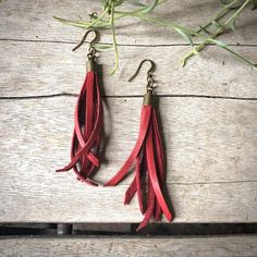 -These tassel earrings are made from soft red deerskin leather.  Part Western, part Boho, part Rock 'n Roll, these little fringe earrings give a big kick to any outfit.-Lightweight enough to wear every day. -3" - 3.5" total length, including earwires.-Earwires are antique-brass.-Deerskin leather is sustainably sourced in the USA.-Ok to get wet.-Available in 10 colors.-Designed and handmade in South Pasadena, CA.Check out more of our awesome earrings here:https://www.etsy.com/shop/ASTALIJewelry?r Adjustable Red Leather Earrings, Adjustable Leather Tassel Earrings, Red Leather Earrings, Creepy Earrings, Awesome Earrings, Jewelry Western, Fringe Earring, Tassel Earring, Leather Earring