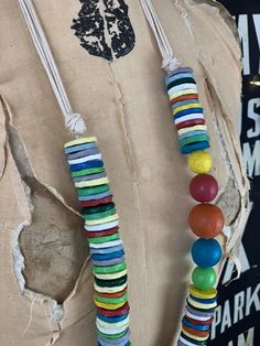 a woman's torso wearing a necklace made out of multicolored wooden beads