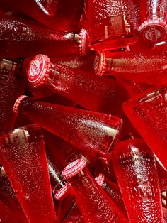 many red glass bottles are stacked together