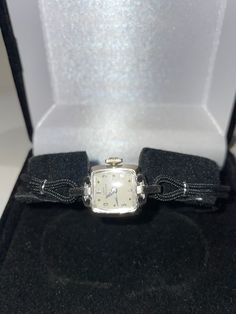 "Beautiful vintage solid 14 karat white gold Lady Hamilton wristwatch. This watch has a 22 jewel mechanical movement that is in good working condition and keeps accurate time. A new black cord band has been attached and will fit a 7.25\" wrist which can be made smaller if need. Simply tell me exact wrist size and I will custom fit for you. Elegant way to wear the time which is nice enough for everyday or those special occasions.." White Gold Ruby Ring, Lady Hamilton, Native American Turquoise Ring, Ruby Ring Gold, Cute Watches, Fancy Rings, Vintage Lady, Engagement Ring Sizes, Mechanical Movement