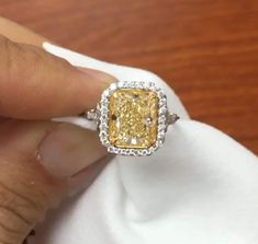 5 CT Yellow Radiant Cut Moissanite Diamond Side two Tone Round Cut Diamond In Band 10K 14K 18K Solid White Gold Engagement Ring Wedding Ring R I N G M E T A L ✥ Metal : 10K 14K 18K Solid White Yellow and Rose Gold, 925 Sterling Silver ✥ Metal Clarity : 100% Pure ✥ Stamp/Hallmark : Yes. Will be Indicated Inside The Ring M A I N S T O N E S ✥ Type : Moissanite  Diamond ✥ Center Diamond Shape : Radiant Brilliant Cut Diamond ✥ Center Diamond Weight : 4 CT ✥ Center Diamond Color : Yellow ✥ Side Diamond Shape : Round Cut Diamond ✥ Side Diamond Weight : 1.2 CT ✥ Clarity : VVS1 ✥ Diamond Cut : Excellence R I N G S I Z E S ✥ All Ring Size are Available ✥ Free Sizing ✥ If You Have any Questions With Regards to Sizing Please Contact as ✥ Please Send me a Message If You Need a Size not Listed S H I P Yellow Platinum Diamond Wedding Ring, Moissanite Diamond Ring With Diamond Accents For Marriage, Moissanite Ring With Diamond Accents For Marriage, Anniversary Halo Ring With Radiant Diamond Cut, Anniversary Radiant Cut Diamond Halo Ring, Radiant Cut Diamond Halo Ring For Anniversary, Radiant Cut Halo Ring With Diamond Cut For Anniversary, Luxury Wedding Halo Ring Gia Certified, Luxury Gia Certified Halo Wedding Ring