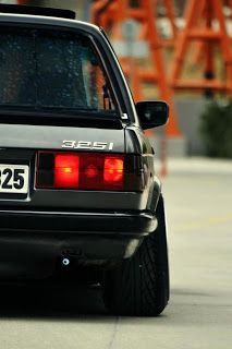 the back end of a black car with its license plate on it's bumper