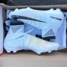 a pair of white nike soccer cleats in a box