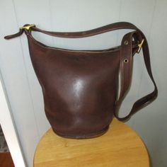 Coach G7d 9953 Vintage 1990's Brown Leather Bucket/Feed Bag Shoulder Strap Purse. Made In Usa. Very Nice Condition. Very Clean, No Major Flaws. Few Minor Scratches. Zip Closure. Brass Hardware. Measures: Height - 12" Top To Bottom Of Bag Width At Bottom - 10-1/2" Across Width At Top - 12-1/2" Across Adjustable Strap Bottom Diameter - 7x7" Classic Bucket Bag With Brass Hardware, Classic Bucket Shoulder Bag With Brass Hardware, Classic Coach Shoulder Bag With Brass Hardware, Vintage Leather Bucket Bag With Removable Pouch, Vintage Bucket-shape Travel Bag, Vintage Bucket Shoulder Bag For Formal Occasions, Vintage Bucket Travel Bag, Vintage Formal Bucket Shoulder Bag, Classic Coach Crossbody Bucket Bag