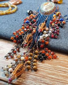 an assortment of beaded jewelry is laying on a table