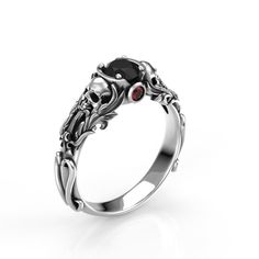 Beautifully crafted skull engagement ring with vintage design, and wing accents. This ring features a 5mm round Black Moissanite, OR Black diamond center stone.  Perfect for the Goth bride or love in your life!  To see my collection of Skull themed rings, click here: https://www.etsy.com/shop/MetalWendler?ref=seller-platform-mcnav&search_query=skull Ring Specs: ● Band is 7.2mm at widest point of Floral Filigree, then tapers down to 3.2mm at the back of shank ● Available in Silver, or 10-18k whit Black Promise Ring, Gothic Promise Ring, Emo Promise Rings, Elegant Skull Ring For Anniversary, Elegant White Gold Skull Ring For Promise, Black Skull Ring For Anniversary, Elegant White Gold Skull Promise Ring, Gothic Skull Ring For Formal Occasions, Gothic Skull Wedding Rings