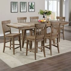 a dining room table with six chairs around it