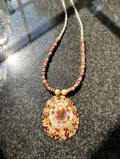 a necklace that has a shell on it