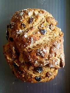 some type of bread with raisins and powdered sugar on top