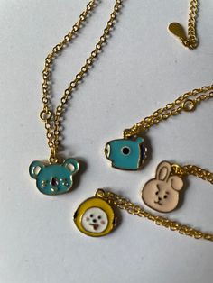 Introducing the BT21 Gold Plated Chain and Character Pendant, the perfect accessory for any BTS fan! This stunning gold chain features adorable BT21 characters including Koya (RM), Chimmy (Jimin), Cooky (Jungkook), and Mang (JHope). The chain measures approximately 45cm and is perfect for adding a touch of Kpop style to any outfit. Please note that this is an unofficial/fan made product and will be sent in a beautiful purple velvet gift bag. Sourced from a company in China, this one-of-a-kind pi Playful Gold Jewelry With Adjustable Chain, Playful Gold Charm Necklace, Playful Gold Necklaces With Charms, Cute Personalized Gold Charm Necklace, Cute Gold Chain Jewelry, Cute Gold Jewelry With Adjustable Chain, Playful Gold Charm Necklace As Gift, Cute Gold Necklace With Adjustable Chain, Bt21 Characters