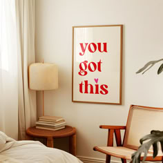 a bedroom with a bed, chair and poster on the wall above it that says you got this