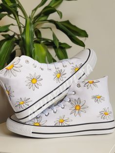 "-🌼DAISY DESIGN🌼- 🌈DESCRIPTION: You will receive a unique pair of shoes which I will personally paint by hand just for you.  I create your shoes from scratch by hand in my little studio. The main design is painted on the outside of the shoes only, while on the inside the shoes are painted with the same minimalist decorations to match with the outside. 🔥UNIQUE: As the shoes are PAINTED BY HAND, the design may slightly vary from the picture. Each design is unique in its own way. 🎨CUSTOMISE THEM: As the shoes are made to order, feel free to make them even more unique. In fact it is possible to customise them, adding a text, a date or a name on the inside of the shoes or even in the corner, on the outside next to the characters. Simply leave me a note at the checkout with the details you Artistic White Sneakers For Spring, Artsy White High-top Sneakers, Hand Painted White Custom Sneakers For Summer, Hand Painted White Low-top Canvas Shoes, White Hand Painted Low-top Canvas Shoes, Artistic White High-top Canvas Shoes, White Hand Painted Canvas Shoes With Round Toe, Artsy Hand Painted White Custom Sneakers, Artistic White Canvas Sneakers