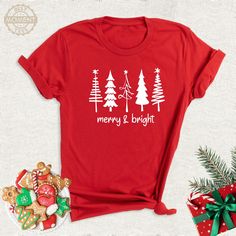 Merry And Bright Christmas Tree Family Party Shirt, Xmas Winter Festive Tshirt, Cute Christmas Group Outfit, Xmas Holiday Couple Tree Tee. Welcome to BestMomentTees! Step into a world of comfort and style with our hand made shirts from the renowned Bella Canvas brand. The solid colors are 100% pure cotton, while the delightful heather colors are a charming blend of 52% cotton and 48% polyester. 🍃 Each shirt is a true labor of love, meticulously created using the innovative DTF printing method. Red Short Sleeve Top For Holidays, Red Short Sleeve Holiday Top, Festive Christmas Crew Neck T-shirt, Christmas Holiday Crew Neck Shirt, Christmas Holiday T-shirt With Letter Print, Festive Crew Neck T-shirt For New Year, Christmas Holiday Graphic T-shirt, Christmas Holiday Letter Print T-shirt, New Year Holiday Crew Neck T-shirt