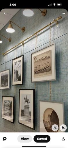 a wall with pictures hanging on it and some lights above the photo are labeled view saved