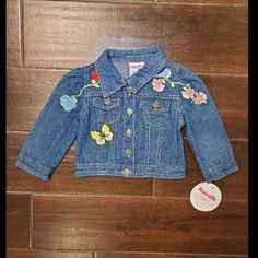 18 M Nannette Denim Embroidered Girls Jacket Featuring A Blue Denim Background With A Yellow Butterfly, Blue Bird, Red/Blue/Pink/Red Flowers Embroidered On The Front. New With Tags Jacket, Coat, Outerwear, Spring Break, Fall, Harvest, Winter, Layering Spring Cute Denim Jacket With Pockets, Blue Cotton Denim Jacket For Playtime, Spring Cotton Outerwear For Playtime, Cute Long Sleeve Denim Jacket For Spring, Spring Denim Jacket For Playtime, Cute Medium Wash Denim Jacket For Spring, Cute Outerwear For Spring Playtime, Cute Embroidered Long Sleeve Denim Jacket, Denim Blue Cute Spring Outerwear