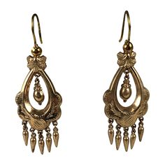 Victorian gold filled articulated long earrings in the Renaissance Revival taste. Gold filled metal has incised foliate motifs with two center hanging urns with small pendant drop fringes and french wire hooks. Excellent Condition. 1880's. L 1.3/4" x W 3/4" Victorian Style Ceremonial Dangle Earrings, Antique Ceremonial Dangle Earrings, Antique Dangle Earrings For Ceremonies, Victorian Chandelier Earrings With Intricate Design, Victorian Chandelier Dangle Earrings With Intricate Design, Antique Engraved Drop Earrings, Antique Gold Engraved Earrings, Antique Chandelier Earrings With Intricate Design, Victorian Filigree Chandelier Dangle Earrings