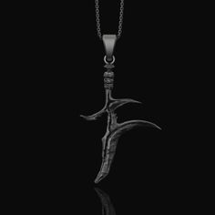 Black Knife Charm Necklace, Elden Ring Inspired, Gift for boyfriend, Geek Gift, Videogame Lover, Elden Ring Pendant Step into the realm of dark fantasy with our Elden Ring Necklace. An emblem of mysticism and power, this piece showcases a beautifully crafted Fantasy Dagger reminiscent of the intricate weapons found in beloved RPG adventures. The Black Knife, set against the backdrop of the Elden Ring, evokes memories of epic quests and powerful symbols from the game. For the adventurers at heart Symbolic Jewelry With Steel Shank As Gift, Fantasy Black Pendant Necklace, Black Fantasy Pendant Necklace, Gothic Jewelry For Halloween, Gothic Streetwear Jewelry For Halloween, Fantasy Engraved Jewelry For Fantasy Events, Gothic Engraved Jewelry For Larp, Black Ankh Metal Jewelry, Black Jewelry For Halloween Fantasy Events