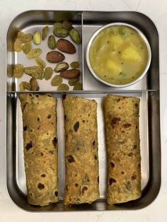 three different types of food in a metal tray