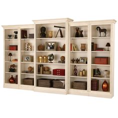 two white bookcases with shelves filled with books and knick - knacks