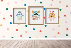 three children's art prints hanging on the wall in a room with polka dots