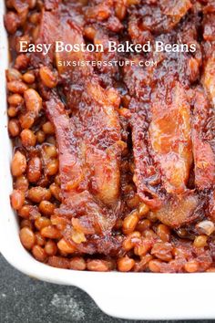 baked beans and meat in a white casserole dish