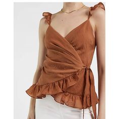 Express Satin Ruffle Wrap Cami Brown, Size Xs. Features & Fabric V-Neck Sleeveless; Ruffle Straps Wrap Front With Side Tie Closure Ruffle Trim On Hem Nylon/Lyocell Cheap V-neck Top With Ruffle Hem, Fitted V-neck Camisole With Ruffles, Fitted V-neck Camisole For Brunch, Sleeveless Ruffle Top For Date Night, Chic V-neck Ruffled Camisole, Chic Fitted Camisole For Brunch, Fitted Sleeveless Blouse Tank Top For Brunch, Fitted Sleeveless Blouse For Brunch, Chic V-neck Camisole For Brunch